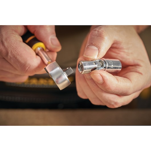 STANLEY STMT86011-0 ratcheting tool and socket in hand, close-up photography of tool connection.