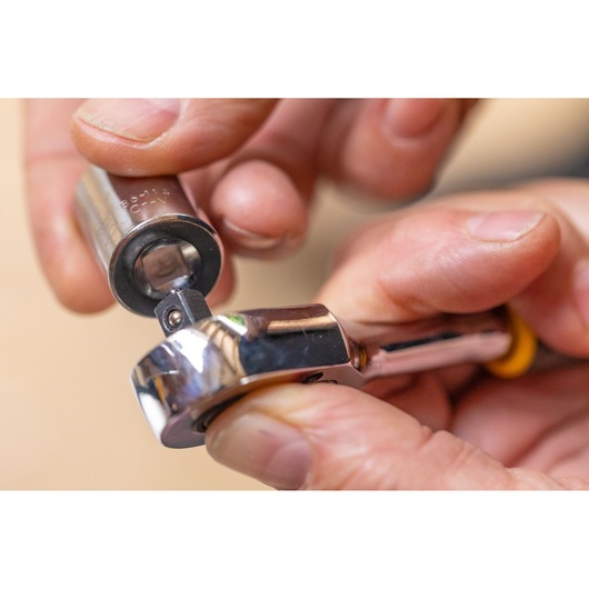 STANLEY STMT86104-0 ratchet and socket held in hands, close-up photo, tool category.