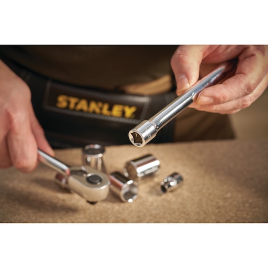 STANLEY STMT86207-0 socket wrench and chrome sockets in close-up on workbench.
