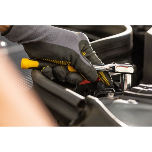STANLEY STMT86309-0 ratchet wrench in use, close-up, yellow and black handle, automotive setting.