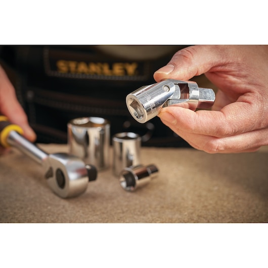 STANLEY STMT86411-0 socket universal joint and ratchet with chrome finish on workbench, photography close-up.