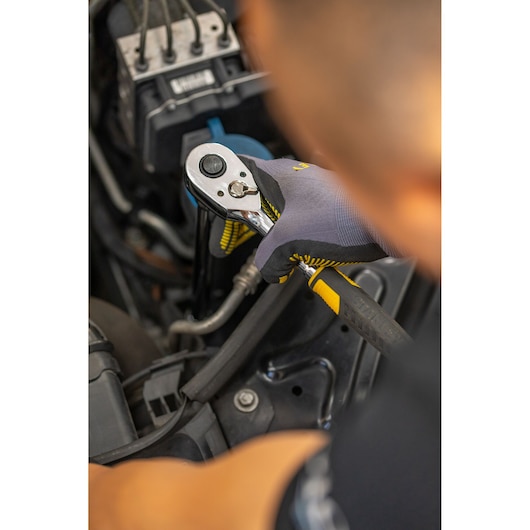 Photo of STANLEY STMT88941-0 ratchet wrench in use for automotive repair, black and yellow grip visible.