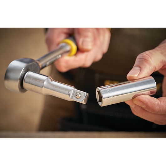 STANLEY STMT88993-0 socket wrench and socket held in hand, close-up photography.