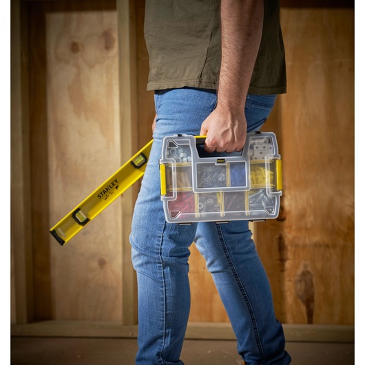 STANLEY STST1-70720 organizer box with yellow accents held by person, next to STANLEY spirit level.