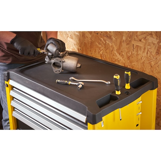 STANLEY STST74305-1 tool chest top with STANLEY hand tools and parts, photographed from above in workshop setting.