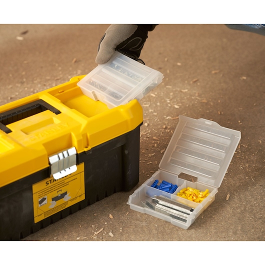 STANLEY STST75785-1 toolbox with open plastic organizer containing screws and wall plugs, close-up.