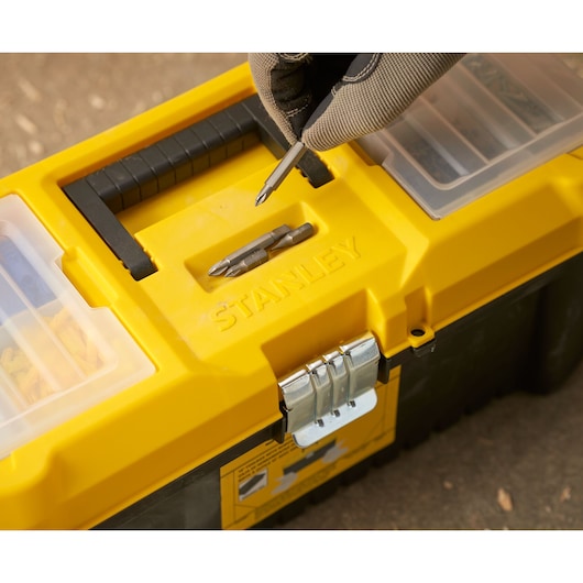 STANLEY STST75785-1 toolbox with yellow lid, metal latch, and screwdriver bits, close-up photo.